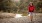 a person with a backpack walking on a dirt path